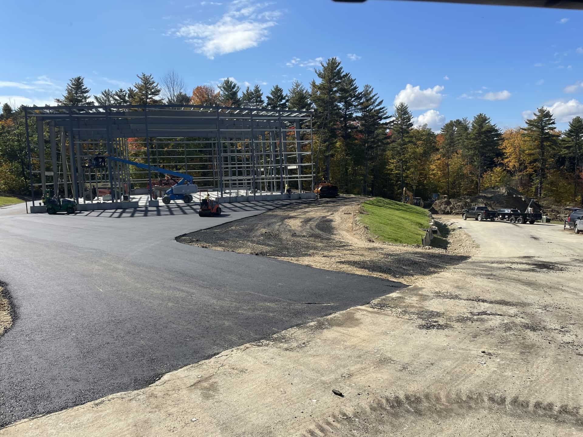 Industrial paving near a steel-frame building under construction